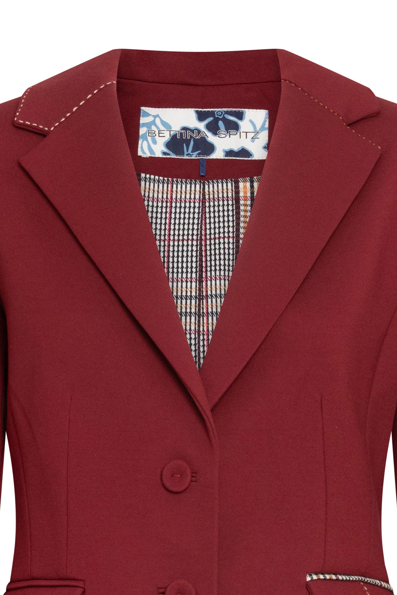 Detalle frontal de solapas y botones del blazer vino